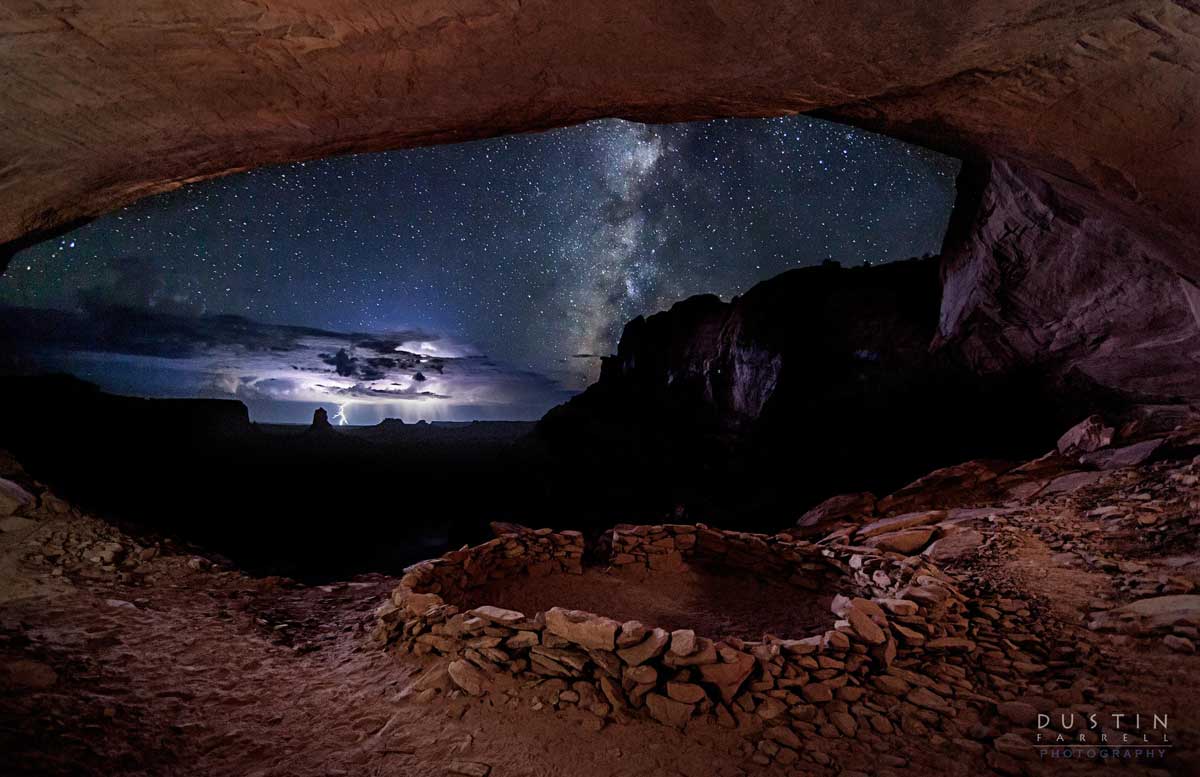a perfect storm captured from the giant window of the false kiva in canyonlands, utah