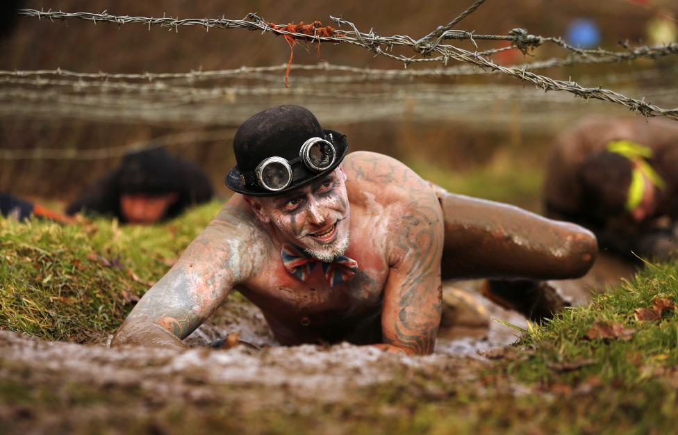 13 Photos From The 2015 Tough Guy Race A competitor crawls beneath barbed wire during the Tough Guy event in Perton, central England