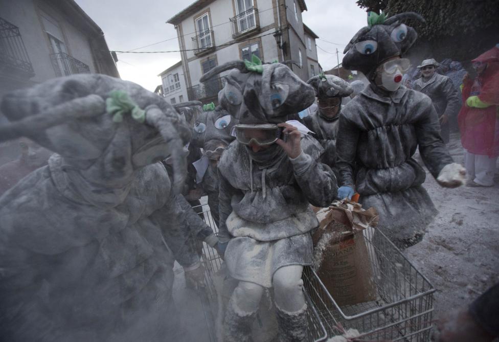 Revellers participate in a flour fight during the "O Entroido" festival in Spain's northwestern village of Laza