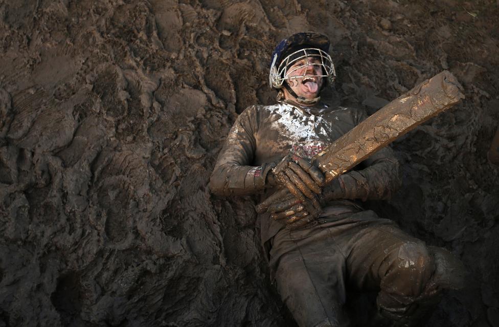13 Photos From The 2015 Tough Guy Race A competitor dressed as a cricketer lies in the mud during the Tough Guy event in Perton