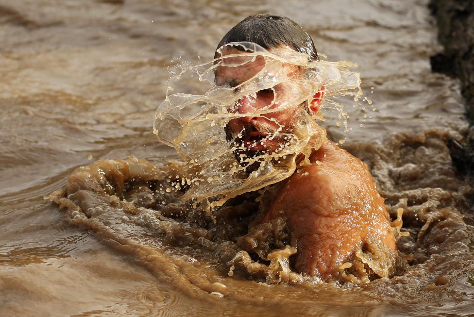 13 Photos From The 2015 Tough Guy Race A competitor shakes water off his head during the Tough Guy event in Perton, central England