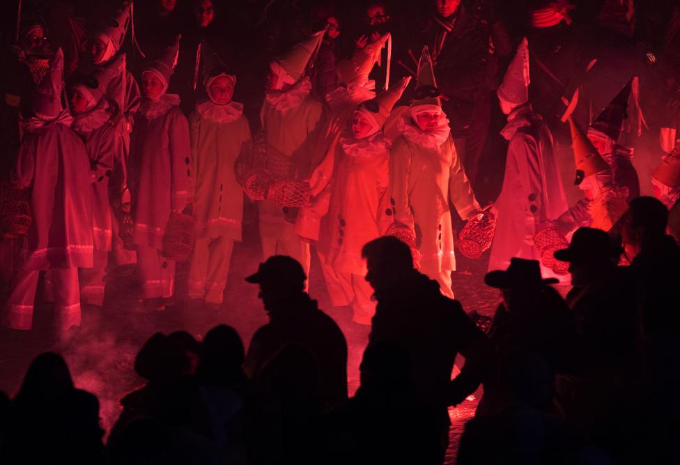 Crazy and Wonderful Photos from Carnivals Around the World 2015 children dressed as pierrot dance around flares during the rondeau at the carnival event in binche