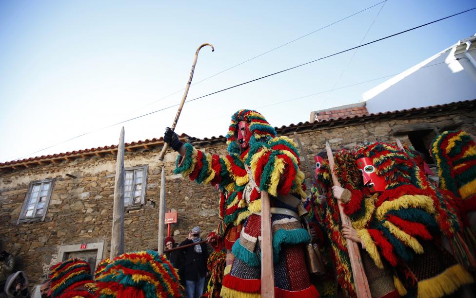 revellers wearing masks perform during a parade at the carnival festivities, in portugal's northeastern village of podence