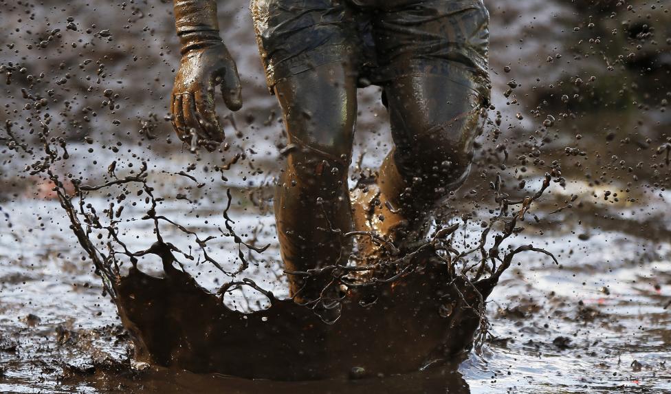 13 Photos From The 2015 Tough Guy Race A competitor runs through mud during the Tough Guy event in Perton, central England