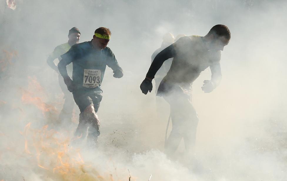 Competitors run through smoke and fire during the Tough Guy event in Perton