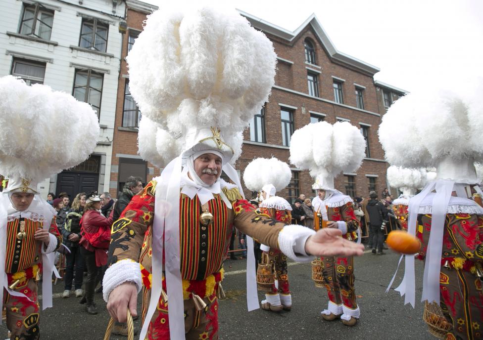 Crazy and Wonderful Photos from Carnivals Around the World 2015 gille of binche throws an orange while taking part in the parade during the carnival event in binche