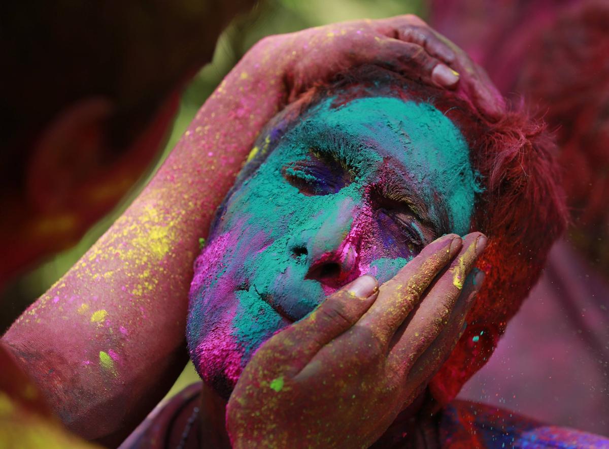colored powder was applied to a man’s face while celebrating holi in mumbai on march 6. (danish siddiqui/reuters)