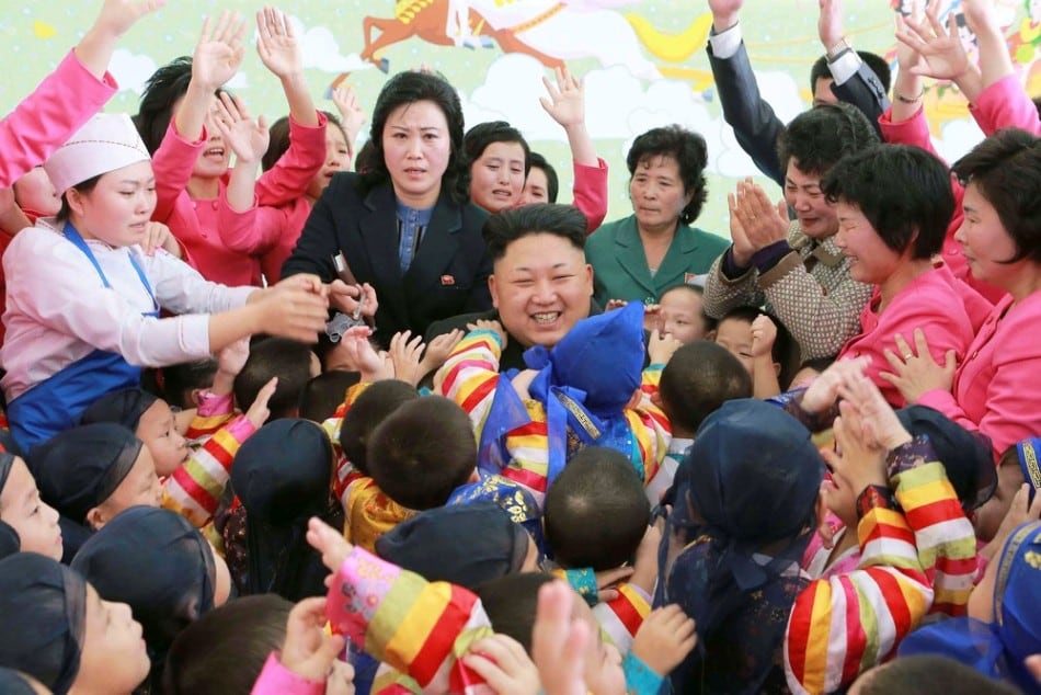 North Korean leader Kim Jong Un (C) poses for a picture with children during a visit to the Pyongyang Baby Home and Orphanage on New Year's Day in this photo released by North Korea's Korean Central News Agency (KCNA) in Pyongyang January 2, 2015. (Photo by Reuters/KCNA)