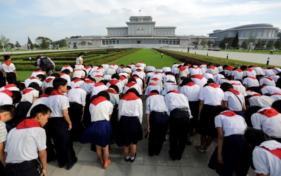 North Korean students bow in front of Kumsusan Palace of the Sun, where the embalmed bodies of North Korea's founding leader Kim Il-sung and his son Kim Jong-il lie in state, in Pyongyang July 25, 2013. (Photo by Jason Lee/Reuters)
