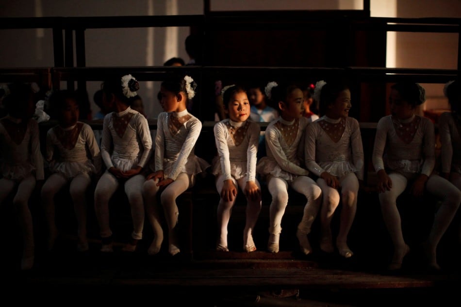 Girls sit backstage before their performance at a local school in Rason city, northeast of Pyongyang, August 29, 2011. (Photo by Carlos Barria/Reuters)