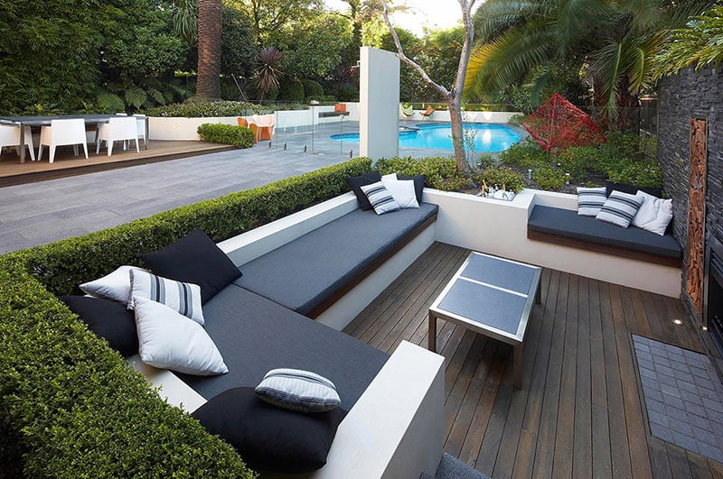 outdoor-living-with-wooden-floor-tiles-garden-plants-sunken-lounge-views-to-pool-and-surrounding-greenery-ideas