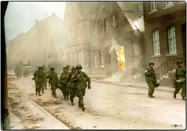 These 50 Astonishing WWII Colorized Photos Look Like They were Taken Yesterday troops of the 17th u.s. airborne division, first allied airborne army, march past a blazing building in appelhülsen, germany, as they advance toward the city of münster, nine miles to the northeast. first allied airborne army troops had landed east of the rhine river on march 24th 1945. (colorized by doug)