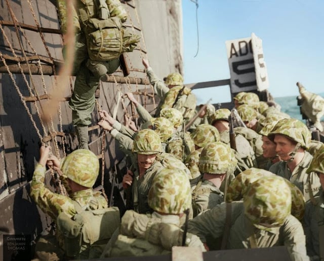 United States Marines climbing down the nets into landing craft during the Battle of Peleliu, September-November 1944. (Photographer: Griffin Image courtesy of the United States Marine Corps History Division, Peleliu 117058. Colorized and researched by Benjamin Thomas from Australia)