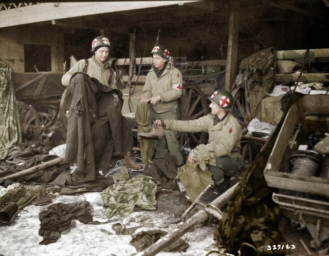 These 50 Astonishing WWII Colorized Photos Look Like They were Taken Yesterday medics of the us. 5th infantry division examining gi clothing found with german-captured equipment after the liberation of the area, near diekirch in luxembourg on the 20th of january 1945. (source - sc-327129 signal corps photo eto-hq-45-9223 -horton. colorized by joey van meesen from the netherlands)