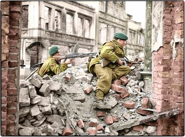Royal Marines from 45 (RM) Commando, 1st Commando Brigade on the look-out for snipers among the ruins in Osnabrück, Lower Saxony, Germany. 4th of April 1945. (Source - IWM BU 3057. Photographer - Sgt.Laws No 5 Army Film & Photographic Unit. Colorized by Doug)