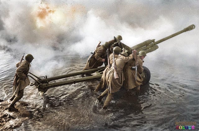 Soviet artillerymen transporting a 76-mm divisional gun M1942 (ZiS-3) during the forced crossing of the Oder River, Germany, c. December, 1944. (Photograph by Dmitri Baltermants. Colorized by Royston Leonard from the UK)