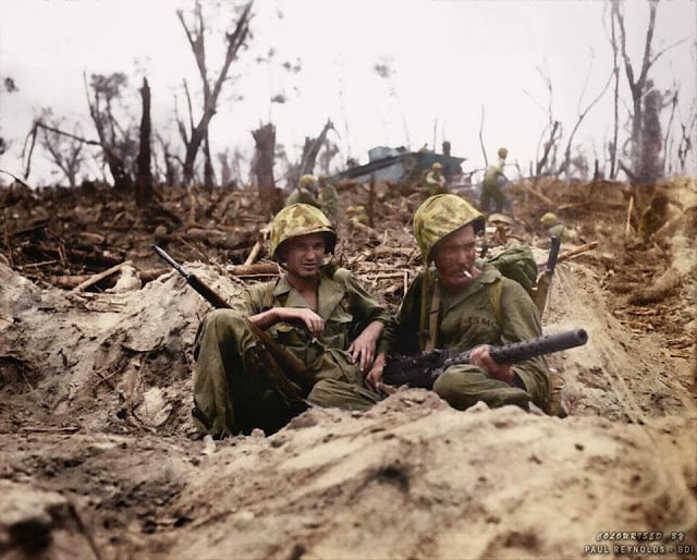 These 50 Astonishing WWII Colorized Photos Look Like They were Taken Yesterday marine pfc. douglas lightheart (right) cradles his .30 caliber m1919 browning machine gun in his lap, while he and marine pfc. gerald thursby sr. take a cigarette break, during mopping up operations on peleliu on 14th september 1944. (colorized by paul reynolds. historic military photo colourisations)