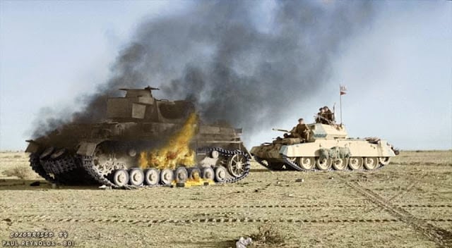 A British Crusader tank passes a burning German Panzer IV tank during 'Operation Crusader'. Cyrenaica (the eastern province of Libya). Winter 1941. (Colorized by Paul Reynolds. Historic Military Photo Colourisations)