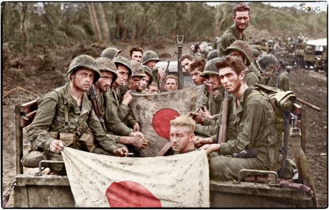 The strain and fatigue of 23 days on the line is shown by Marines of Combat Team 'C', 2/7th US Marines, 1st Marine Division seen here displaying Japanese battle flags captured during the Battle of Cape Gloucester. 14-15th January 1944. (Source USMC 71602. Colorized by Doug)