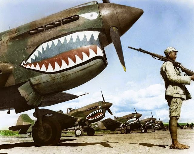 These 50 Astonishing WWII Colorized Photos Look Like They were Taken Yesterday a chinese nationalist soldier guards a row of curtiss p-40 'warhawks' flown by the 'flying tigers' of the american volunteer group (avg). july, 1942. (source - national archives and records administration - 535531. colorized by tom thounaojam from india)