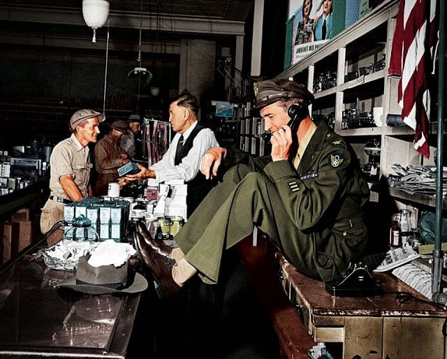 These 50 Astonishing WWII Colorized Photos Look Like They were Taken Yesterday while his father chats with a customer at the hardware store, a uniformed jimmy stewart sets up a date to go fishing,1945. (colorized by john gulizia from america)
