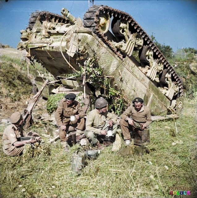 The crew of an up-ended (M4A1) Sherman tank of the 7th Armoured Brigade enjoy a ‘brew’ beside their vehicle while waiting for a recovery team, on the 'Gothic Line' in Italy, 13th of September 1944. Their tank overturned after slipping off a narrow road in the dark. (Source - IWM NA 18551 - Dawson (Sgt), No 2 Army Film & Photographic Unit. Colourised by Royston Leonard UK)