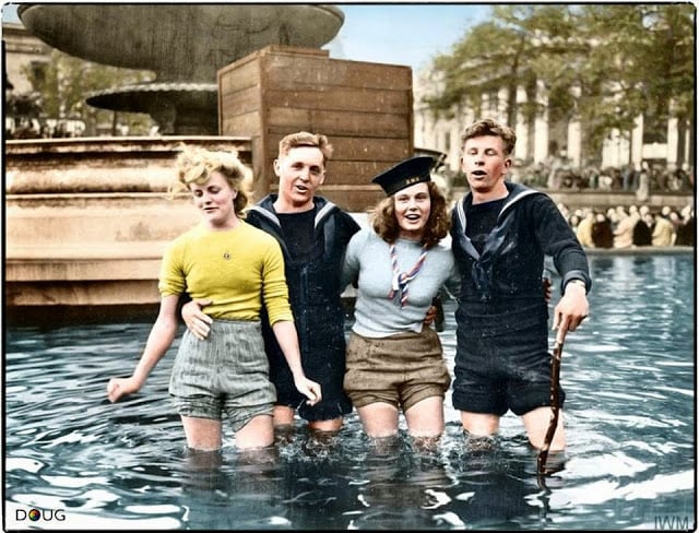 These 50 Astonishing WWII Colorized Photos Look Like They were Taken Yesterday two british sailors celebrate ve day with their girlfriends in the fountains at trafalgar square. london, england. tuesday the 8th of may 1945. (source - © iwm ea 65799. united states army signal corps photographer t g massecar. colorized by doug)