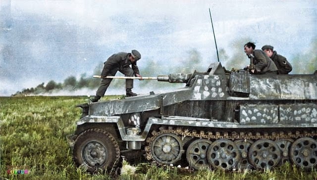 These 50 Astonishing WWII Colorized Photos Look Like They were Taken Yesterday a crew member cleaning the barrel of an sd.kfz. 251/9 - schützenpanzerwagen (7.5 cm kwk 37 l/24) "stummel" on the east front, c. summer 1942. (colorized by royston leonard from the uk)