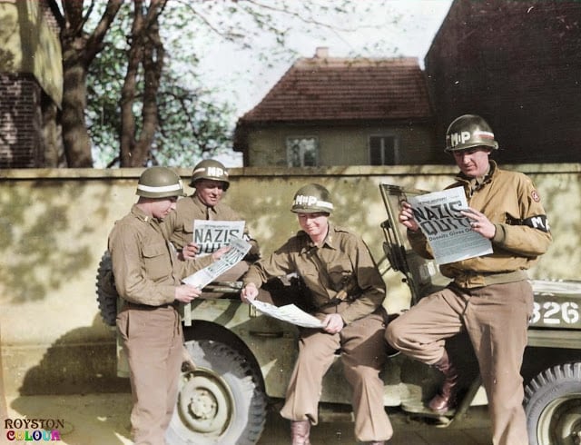 These 50 Astonishing WWII Colorized Photos Look Like They were Taken Yesterday 9th army mps reading of the surrender in the 'stars and stripes' in germany on the 8th of may 1945. (source - u. s. army military history institute - nelson a. shuey photograph collection. colorized by royston leonard uk)