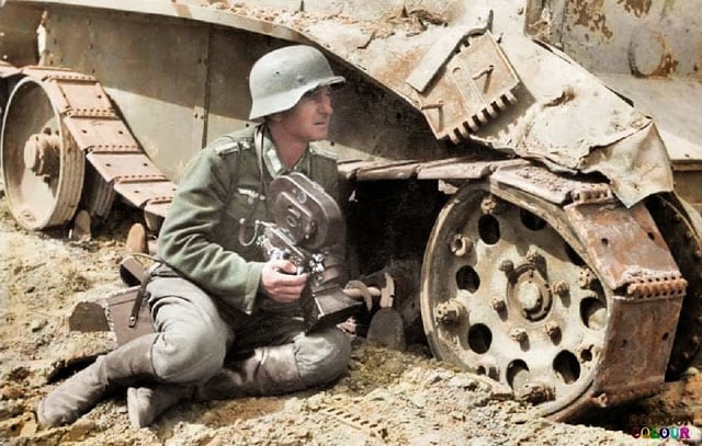 These 50 Astonishing WWII Colorized Photos Look Like They were Taken Yesterday a kriegsberichter (war correspondent) holding an arriflex 35 2 1942 camera 35mm acr 0292 and he is leaning against a knocked out soviet bt-5 light tank. c.1940/41. (colorized by royston leonard from the uk)
