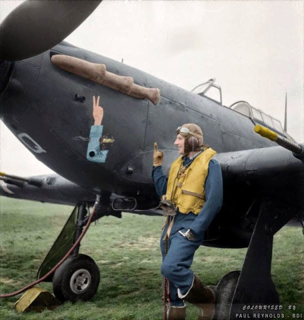 Squadron Leader J.A.F. MacLachlan, the one-armed Commanding Officer of No 1 Squadron RAF, standing beside his all-black Hawker Hurricane Mark IIC night fighter, 'JX-Q', at Tangmere in West Sussex, England. (Source - Royal Air Force official photographer Woodbine G (Mr) © IWM CH 4015. Colorized by Paul Reynolds. Historic Military Photo Colourisations)