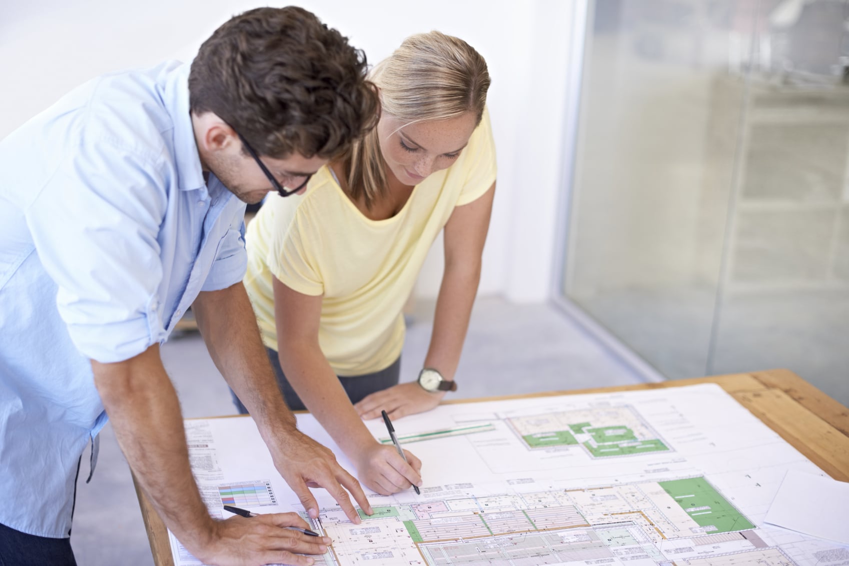 a group of architects discussing elements of a building plan