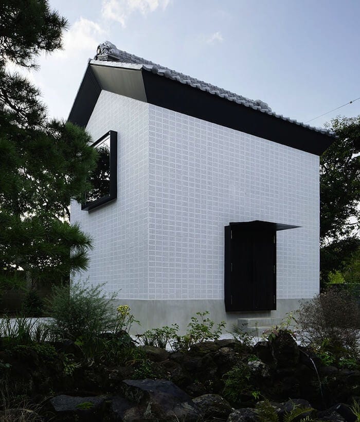a house with bushes in front of a building