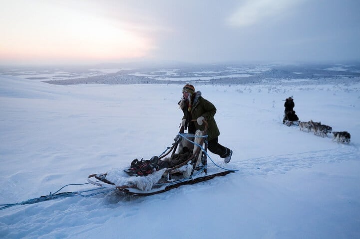 a man riding on top of a snow covered slope