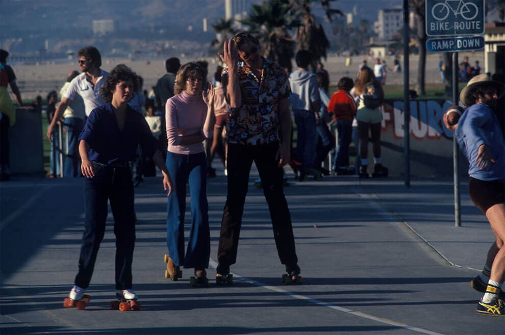 a group of people walking on a city street