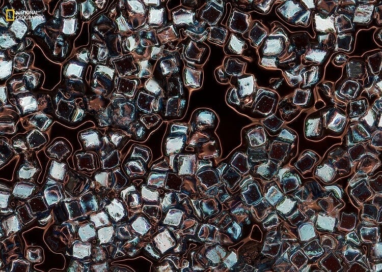 eleanor ryder/2016 national geographic nature photographer of the year. toxic vanity. 3rd place—environmental issues:this image is a magnification of plastic particles in eyeliner, exploring just one facet of the synthetic swarm suspended in our oceans. the particles, lash-lengthening fibers, illuminating powders, and glitters these products contain are in fact tiny pieces of plastic. every time we wash these products from our bodies or ingest them as we lick the glosses from our lips, we unknowingly add to the trillions of microplastic particles currently infesting every level of the ocean. this photograph was taken at falmouth university in cornwall, united kingdom, in may 2016 using a reflective photographic microscope with a stacking panoramic process to create the final image.