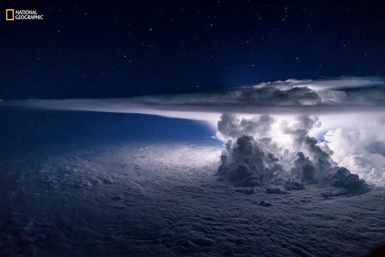 santiago borja/2016 national geographic nature photographer of the year. pacific storm. 3rd place—landscape: an isolated cumulonimbus storm developed over the pacific ocean a few miles south of the coast of panama city. it sat atop a temperature inversion that created a thick overcast layer of clouds. the strong updrafts of the storm quickly reached the tropopause and spread out, creating the characteristic anvil. the strongest updrafts pierced the tropopause and turned into what scientists call the overshooting tops. the entire frame was lit by a single lightning from within the storm in a moonless night on june 16, 2016.