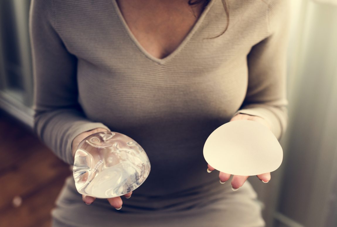 woman holding silicon bags for breast implant PMBFWJX