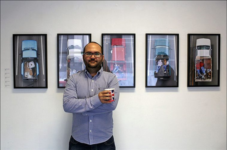 alejandro cartagena in front of his work