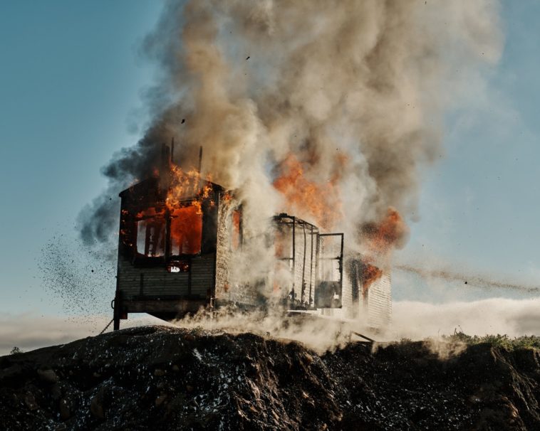 a steam train on a track with smoke coming out of it