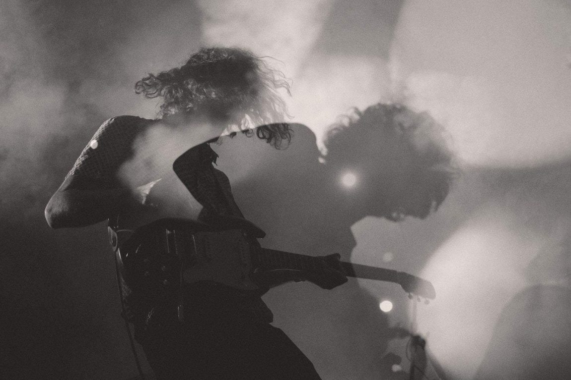 Rock and roll a black-and-white shot of a man playing electric guitar in double exposure