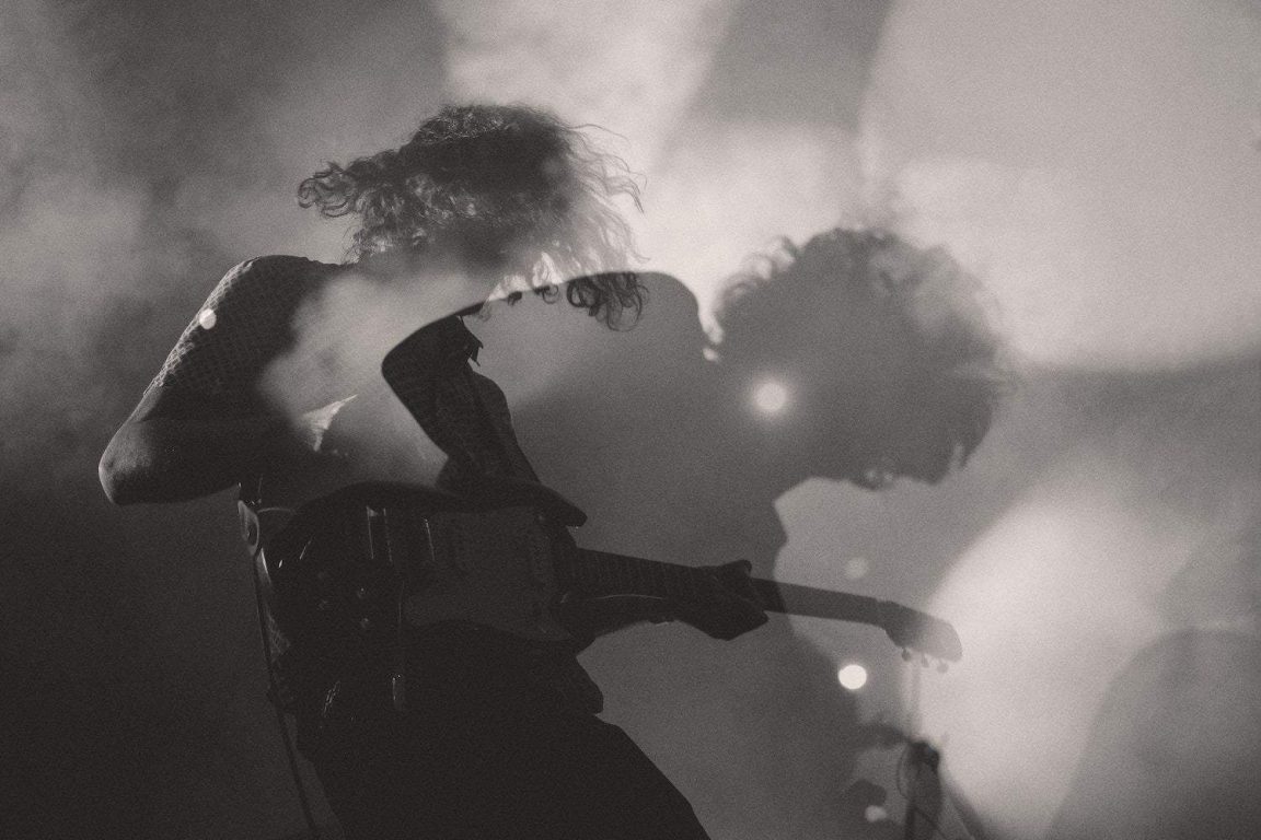 Rock and roll A black-and-white shot of a man playing electric guitar in double exposure