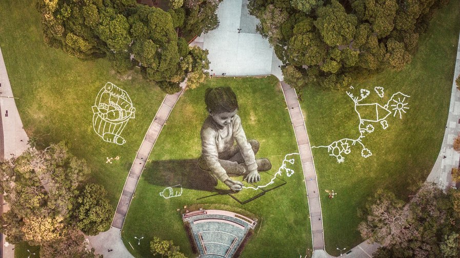 The artist paints 55,000 square feet of grass to celebrate International Recycling Day