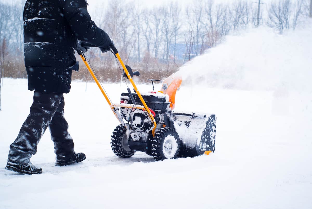 a man cleans snow B8AQH9T