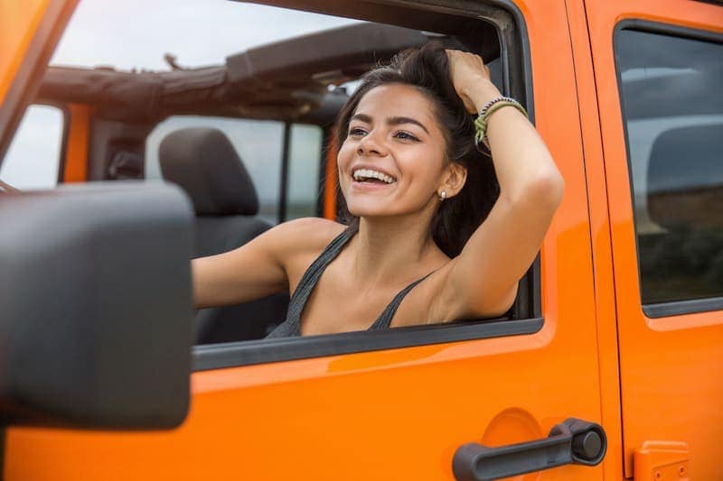happy woman driving a car PETX93U