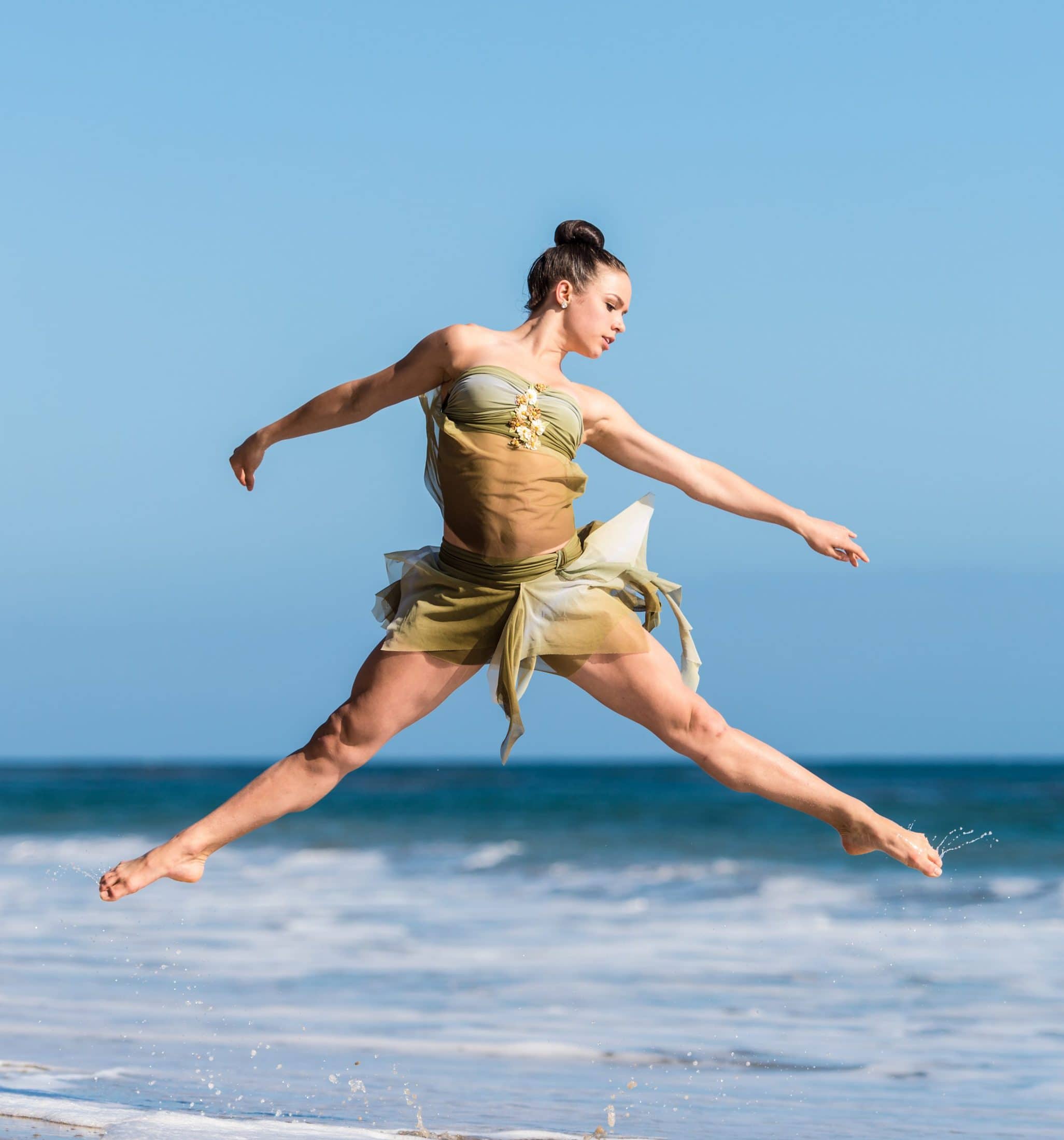 woman dancing beside body of water during daytime