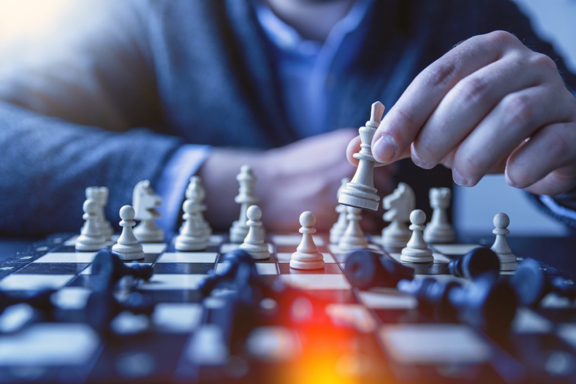 Strategy depth of field photography of man playing chess