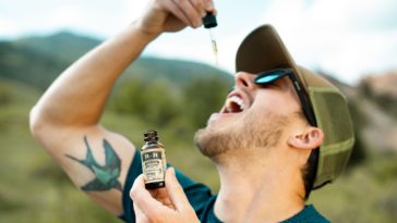 man drinking from droplet