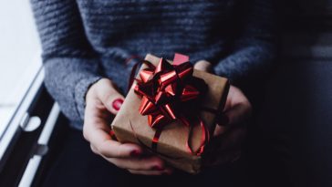person holding present box