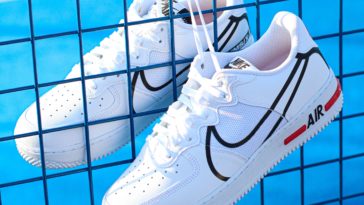 pair of white nike low-top shoes